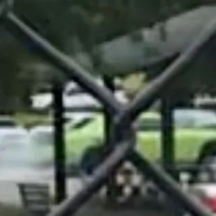 Closer shot of car from tennis courts.