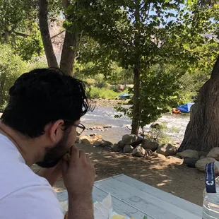 Eating subway while watching river