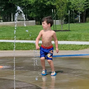 One of my grandkids running around on the splash pad