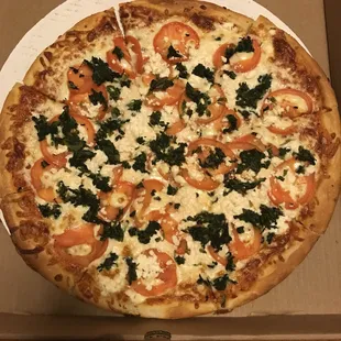 Macedonia pizza: tomato, spinach, and feta. Perfect crust and perfect amount of cheese! A large easily feeds 3-4.