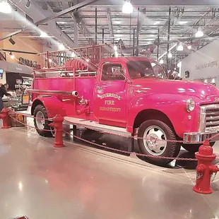 a pink fire truck on display