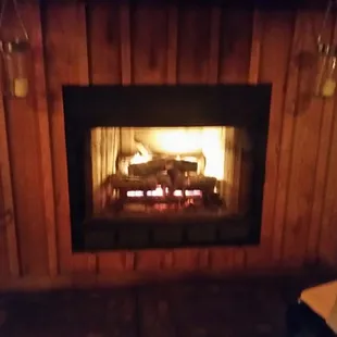 a wood burning fireplace in the corner
