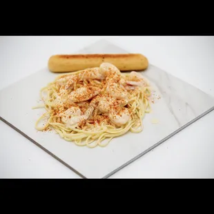 a plate of spaghetti and a hot dog