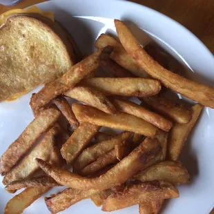 Kids menu: grilled cheese &amp; fries. Big plate of food. She ate the other 1/2 of the sandwich.