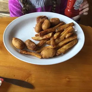 Kids menu corn dogs &amp; fries. Big plate of food.
