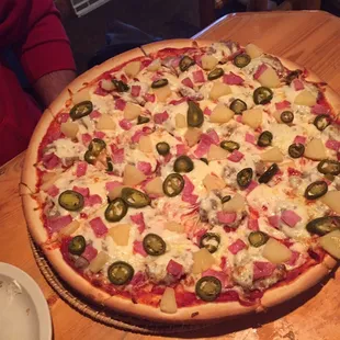 Hawaiian pizza with jalapeños and sausage on medium crust.