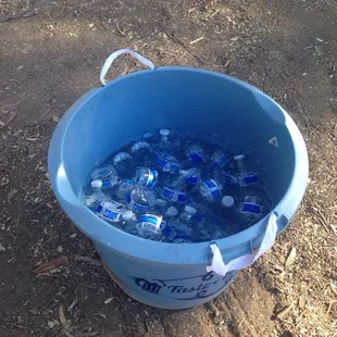 Lots of ice buckets around full of complimentary mini water bottles.