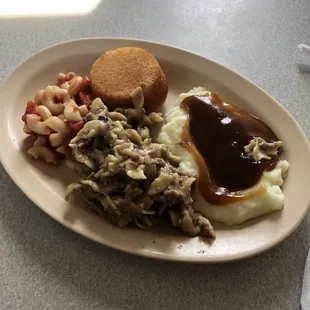 Corn bread, mashed potatoes, macaroni and tomatoes, cornbread