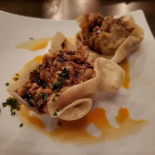 a plate of dumplings and sauce