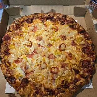 Large pizza with pepperoni, pineapple, and peppers.
