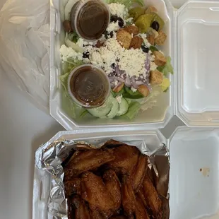 a salad and chicken wings