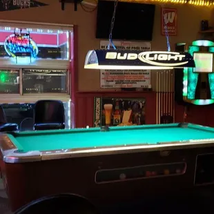 a pool table and neon sign