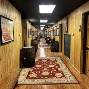 a long hallway with wine barrels