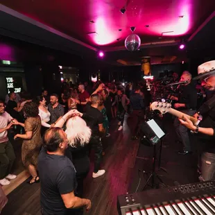 a group of people playing music in a bar