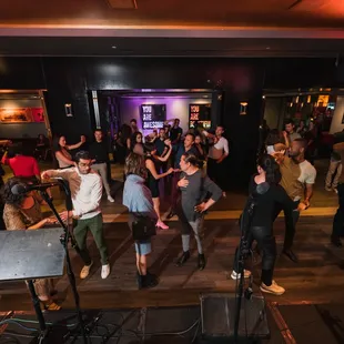 a group of people dancing at a party