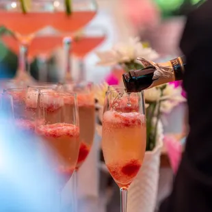 champagne being poured into champagne flutes