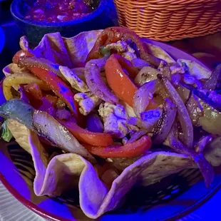 Chicken fajita taco bowl. There was a weird blue light over the table.
