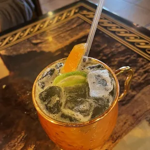 a drink in a copper mug