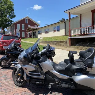 a row of motorcycles parked in front of a house