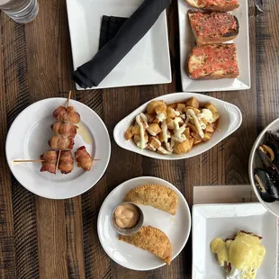 patatas bravas, datiles, pan con tomate, chicken empanadas, benedicto con jamon