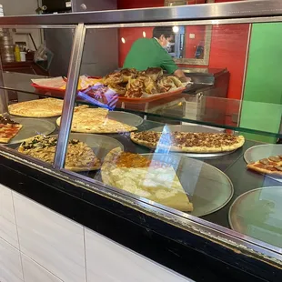 pizzas in a display case