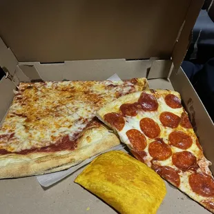 two slices of pizza in a box