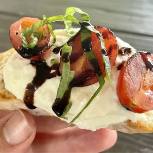 Up close look at a burrata roasted tomato crostini