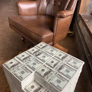  stack of $ 100 bills on a coffee table