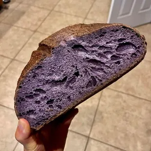 a hand holding a piece of bread