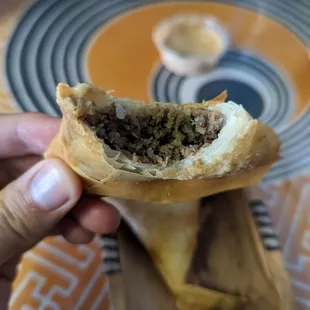 a person holding a piece of food