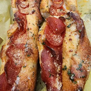 two hot dogs with cheese and pepperoni