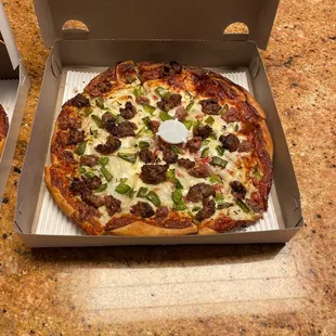 Deluxe pizza with homemade meatballs, onion, sausage and green peppers