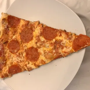 Slice of thin crust pepperoni.