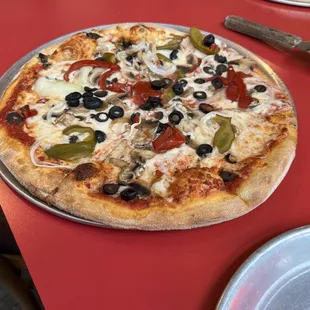 a pizza with olives and peppers