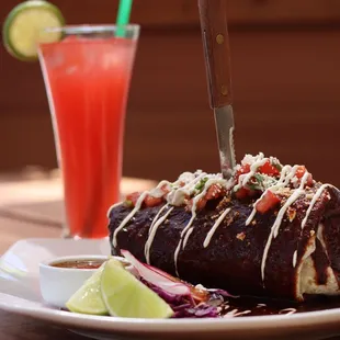 Wet burrito with protein of chioce. Choose between mole, red, or green sauce. Topped with sour cream &amp; pico de gallo. Pair with any lemonade