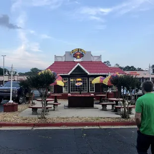 a man walking in front of a restaurant