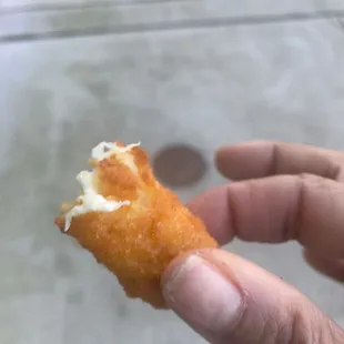 a hand holding a piece of food