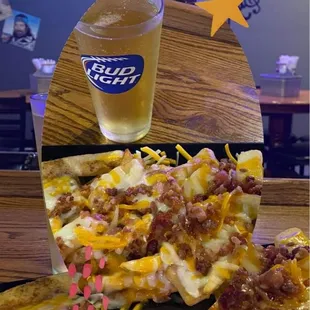 a plate of nachos and a glass of beer