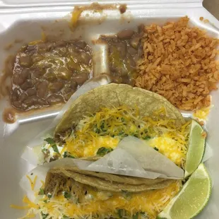 Two Tacos w/ ground beef (added cheese and sour cream), beans &amp; rice.
