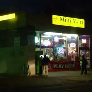 two people standing in front of the store
