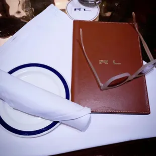 a place setting with a napkin, napkin, and glasses