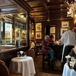 people sitting at tables in a restaurant