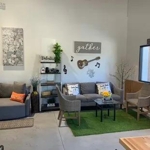 a living room with a couch, chairs, and a coffee table