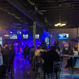 a large group of people sitting at the bar