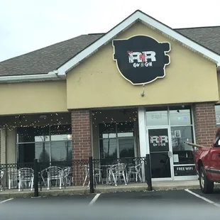 a red truck parked in front of the restaurant