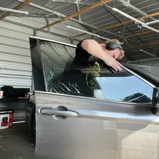 Window tint being fit onto window for installation
