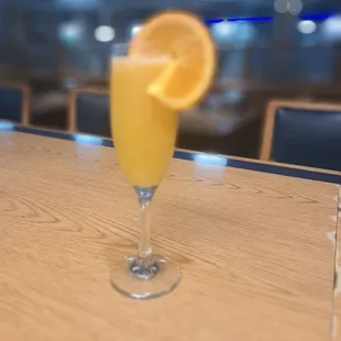 a glass of orange juice on a table