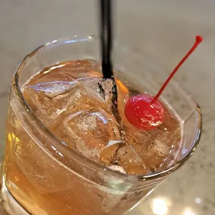 a drink with a cherry on top