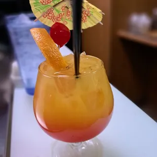 a drink in a glass with an umbrella