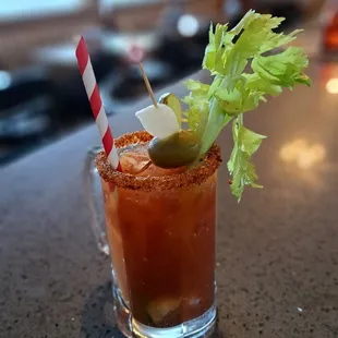a bloody drink with a garnish on top